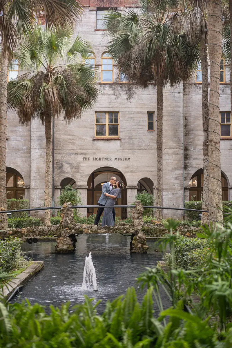 Couple kissing on the bridge over the courtyard fountain