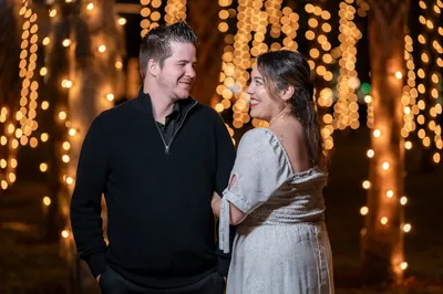 Couple laughing during engagement session with Nights of Lights
