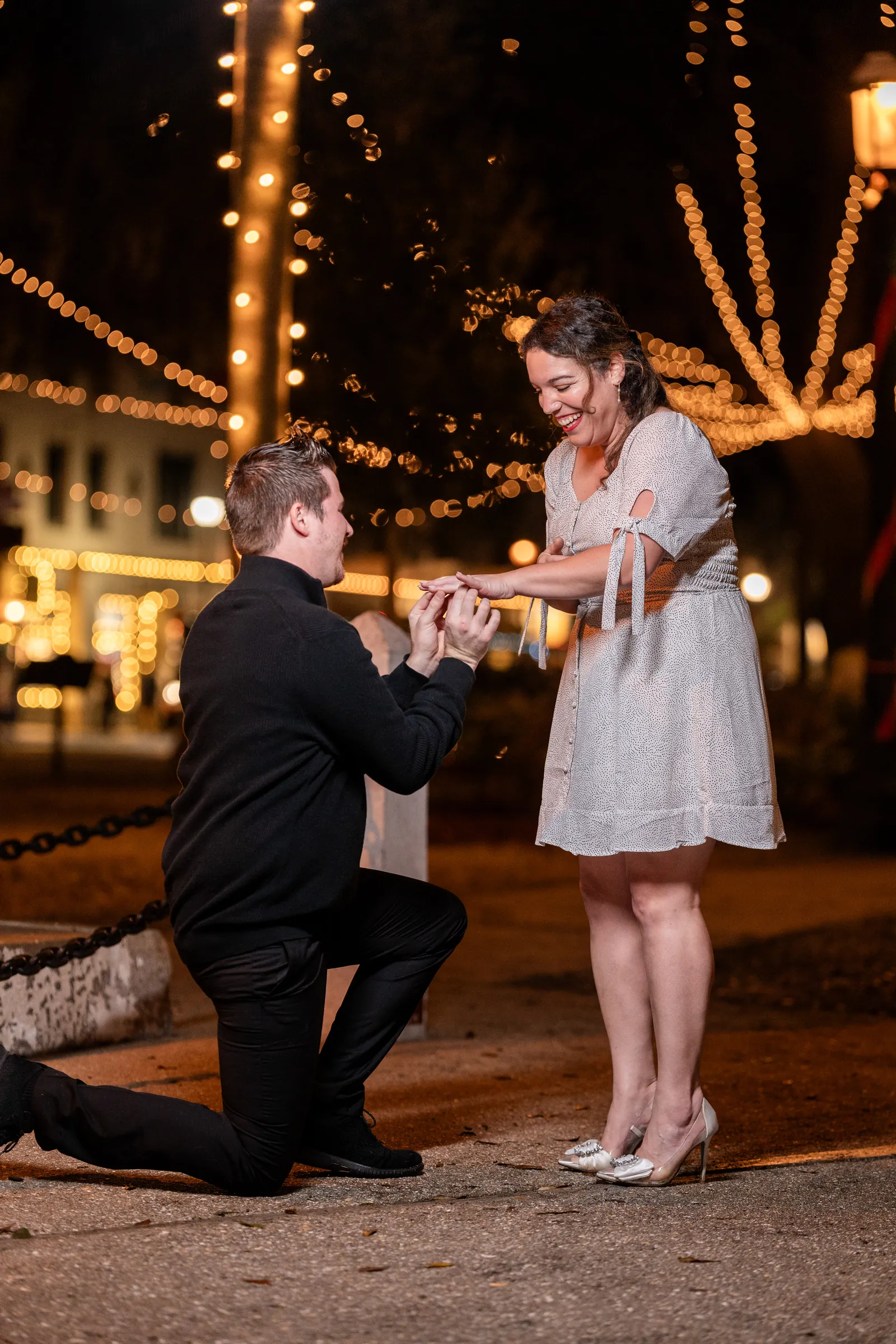 Duncan putting ring on Giselle finger during proposal recreation