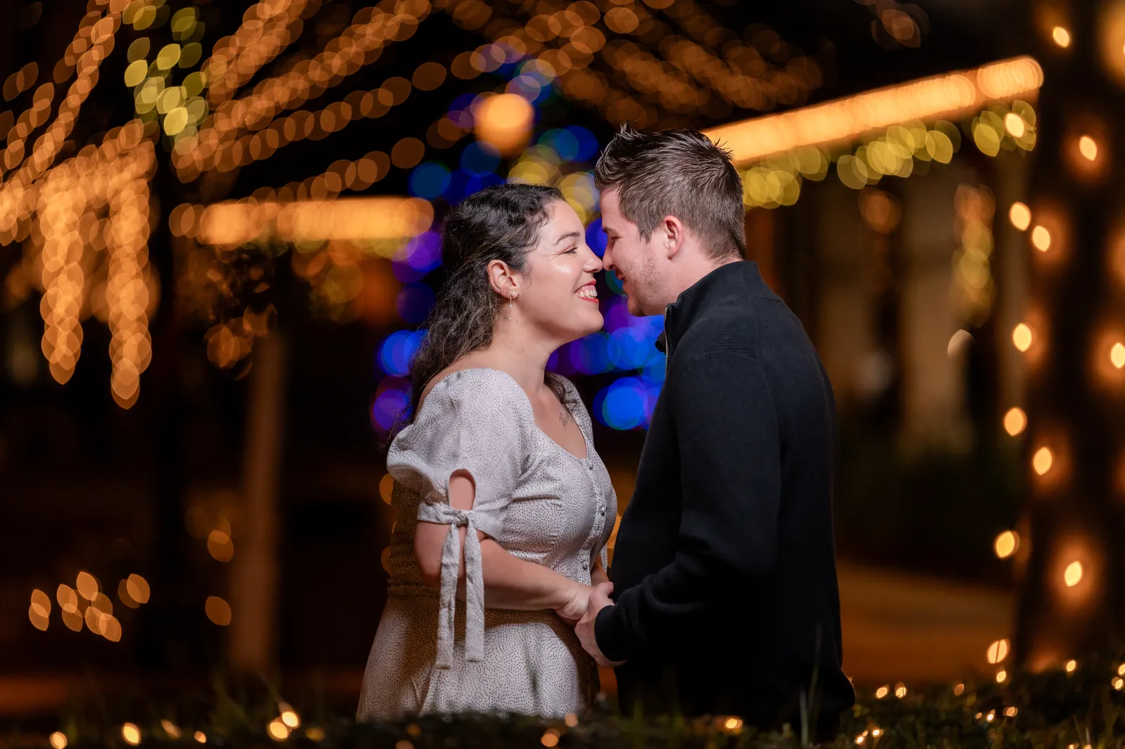 Couple portrait with colorful Nights of Lights bokeh in downtown St Augustine
