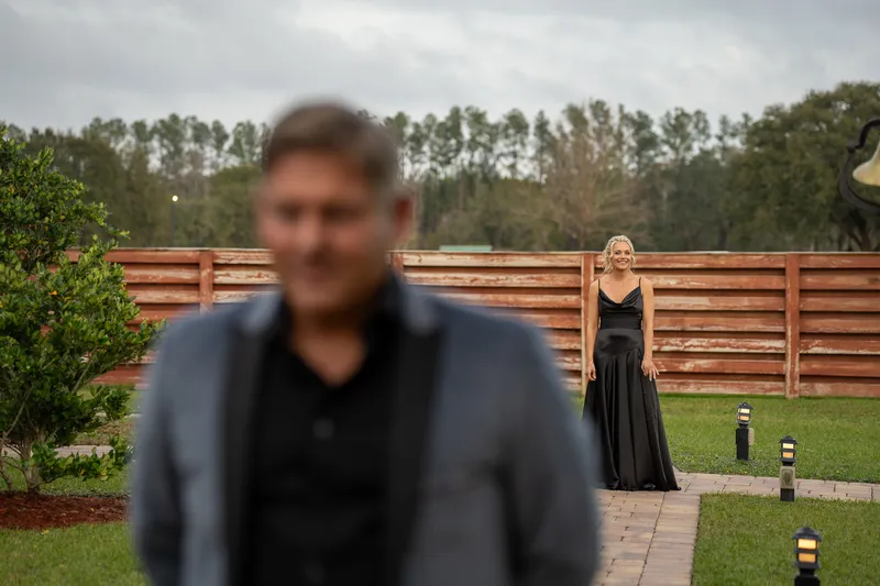 Groom portrait in barn with string lights at Kelly Farm Events