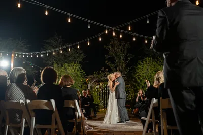 Couple on swing under illuminated oak tree at Kelly Farm Events