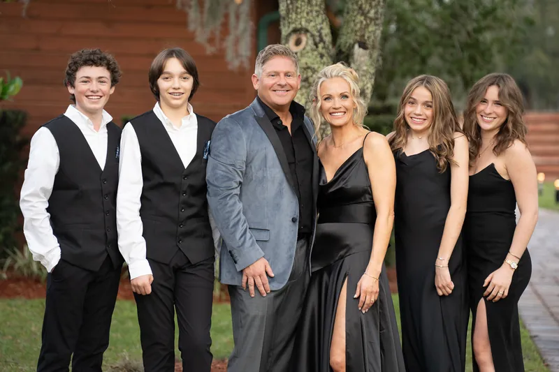 Blended family portrait in black attire at Kelly Farm Events wedding