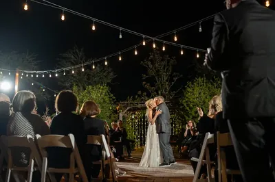 Hamilton and Michelle first kiss at ceremony under string lights