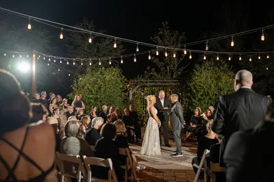 Nighttime ceremony under string lights at Kelly Farm Events