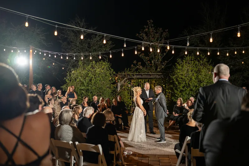 Nighttime ceremony under string lights at Kelly Farm Events