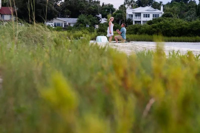 Harley getting down on one knee on sandbar