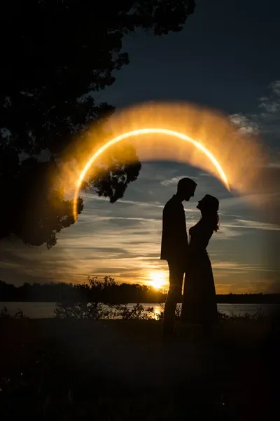 Helen and Saje silhouette with ring of fire sun flare at sunset at Washington Oaks Gardens State Park