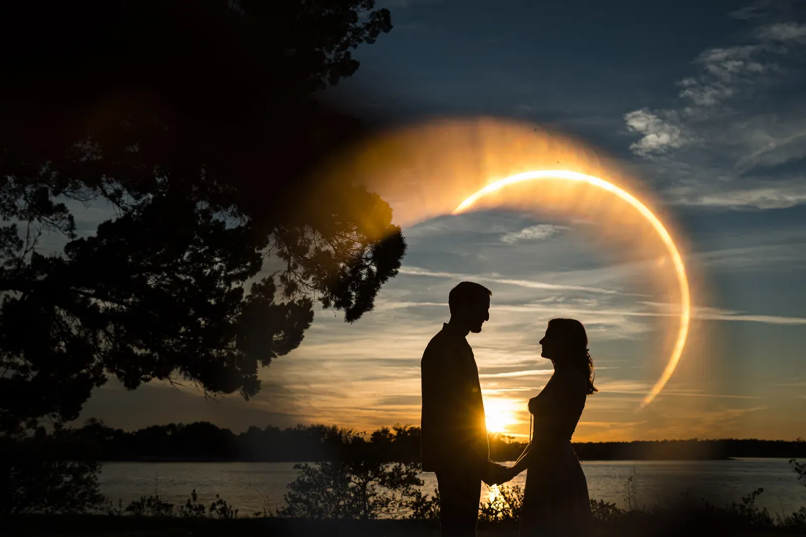 Helen and Saje silhouette with ring of fire sun flare at sunset at Washington Oaks Gardens State Park