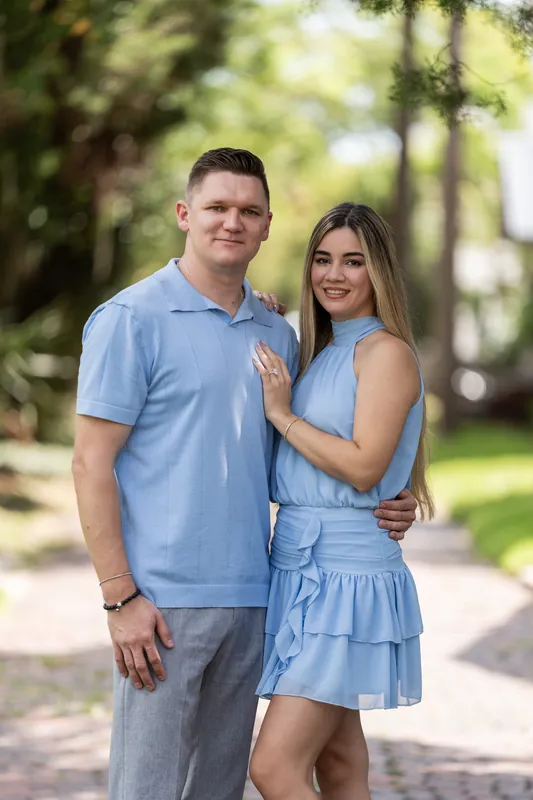 Josy touches Jakub's chest while posing together on a tree-lined path in Downtown St Augustine.