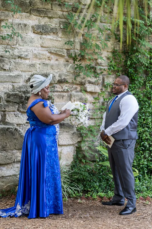 The couple stands against weathered stone with climbing vines, Jazzalynn holding her bouquet during their wedding.