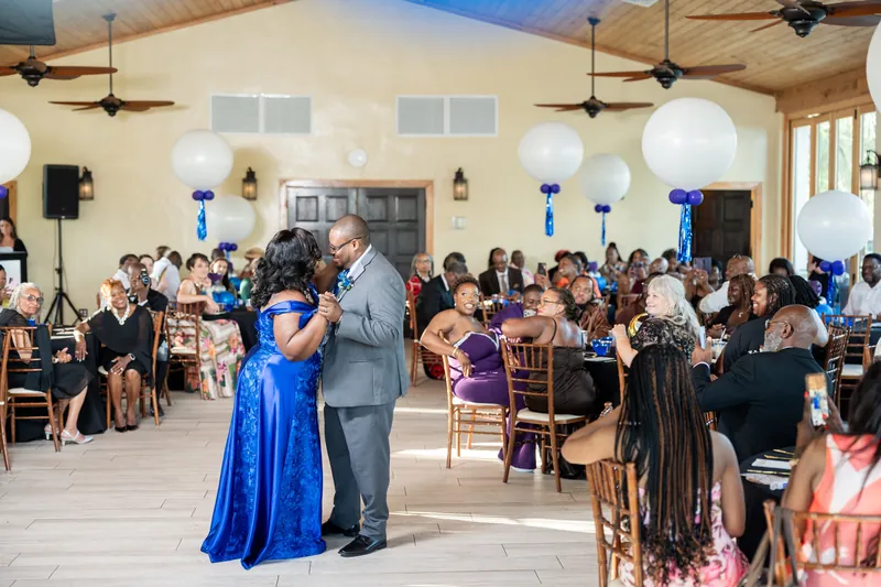Jazzalynn in a royal blue gown dances with Hakeem in a gray suit at the Fountain of Youth Archaeological Park reception hall