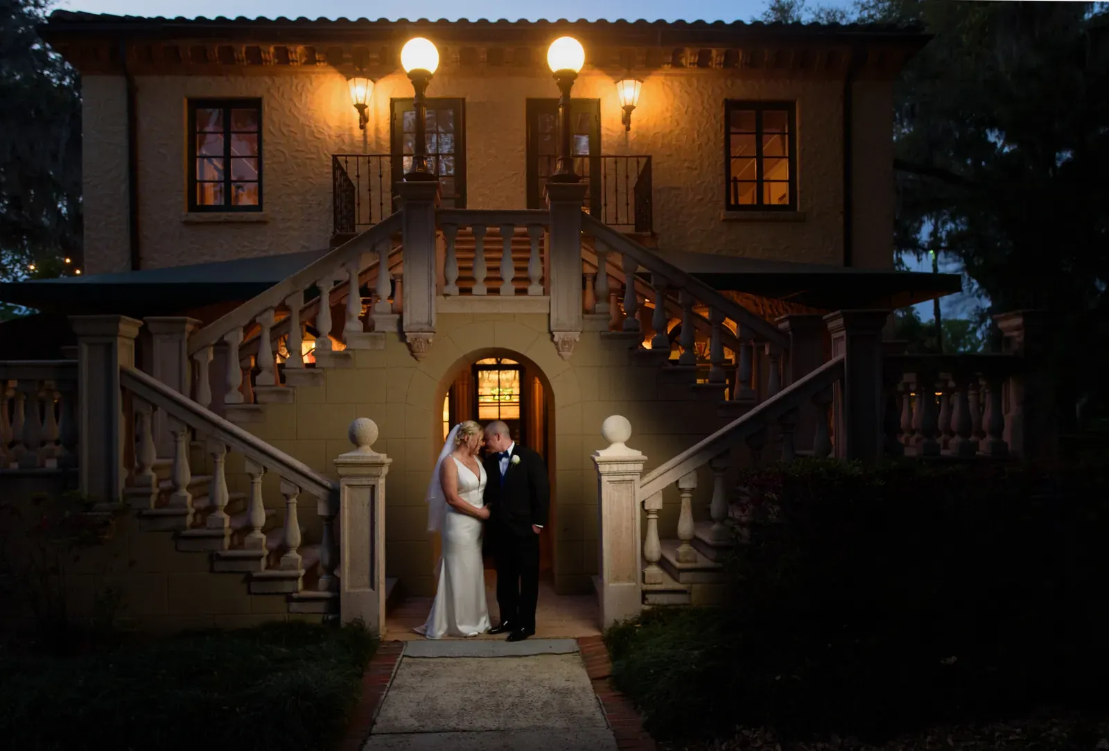 Couple portrait in front of the historic Spanish Renaissance mansion staircase at Epping Forest
