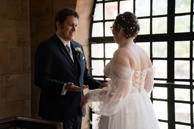 Bride and groom portrait with ceremony arch and blue hydrangeas