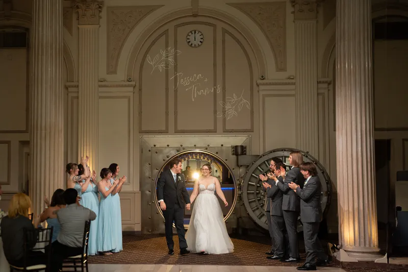Couple grand entrance through vault door at Treasury on the Plaza