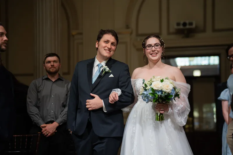 Couple walking down aisle after ceremony at Treasury