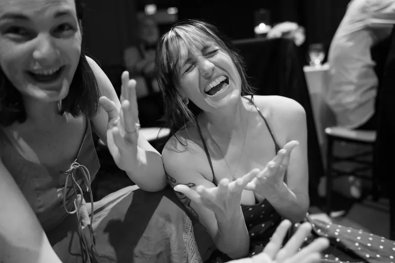 Wedding guest laughing during reception