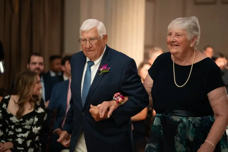 Elderly couple walking smiling warmly