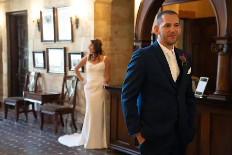 Groom waits bride in background