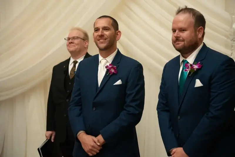 Groomsmen smiling at wedding ceremony