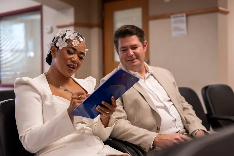 Josh and Diane signing paperwork at the St. Johns County Courthouse