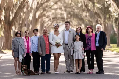 Extended family group photo on Magnolia Street with dog and Spanish moss overhead
