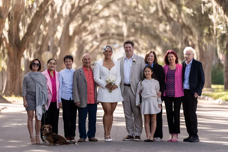 Extended family group photo on Magnolia Street with dog and Spanish moss overhead