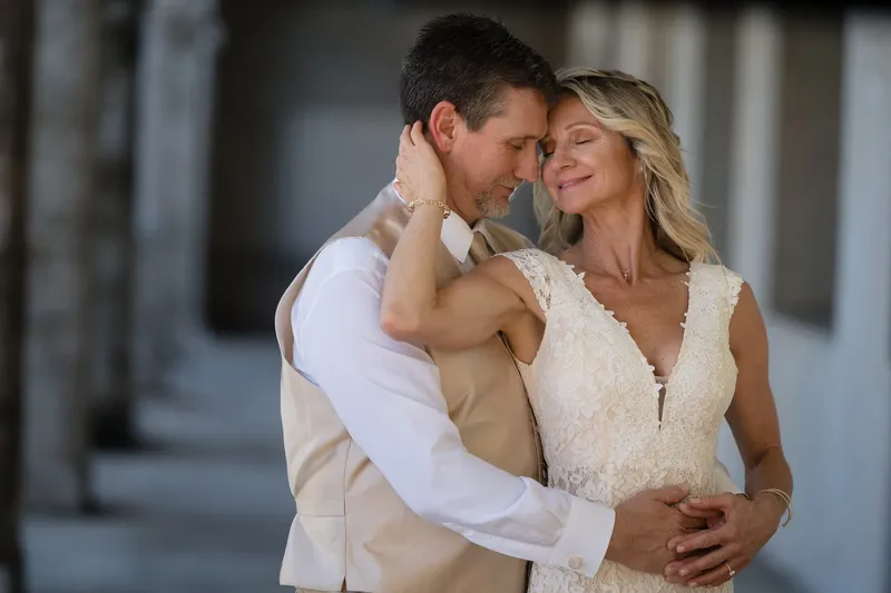 Intimate portrait of couple with foreheads together in the colonnade