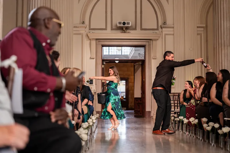 Bridal party entrance with dancing and champagne bottles down the aisle