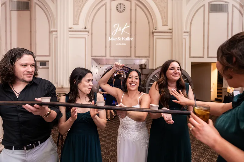 Bride laughing during shot ski with friends at the reception