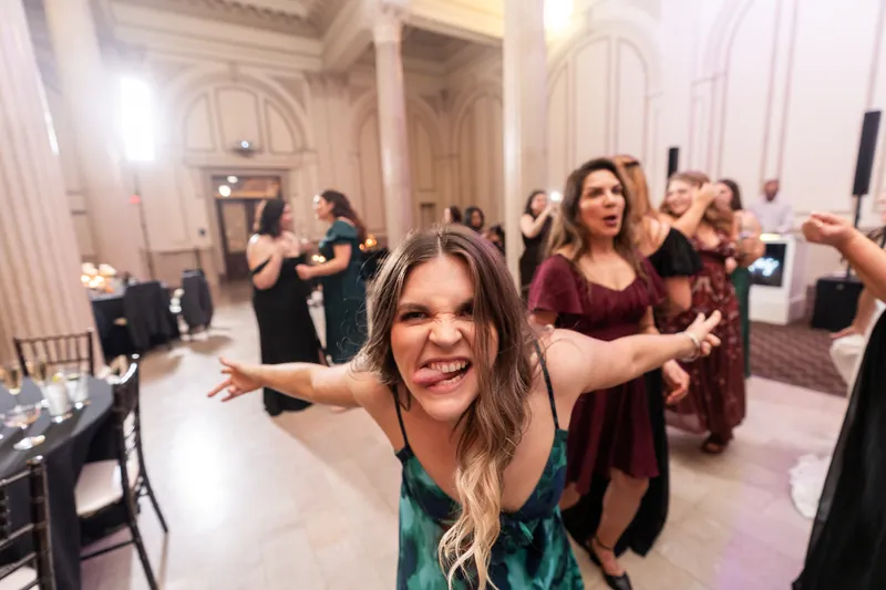 Bridesmaid dancing and making a face at the camera during reception party