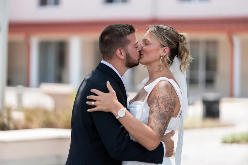 Matt kisses Kalsey outside the courthouse as she wraps her arm around his neck.