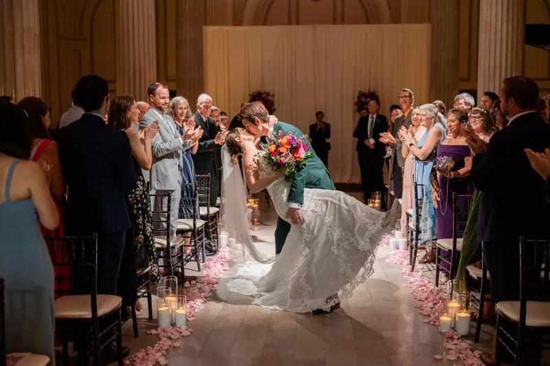 Katherine's train billows dramatically as she and Nathan greet family and friends immediately following the ceremony.