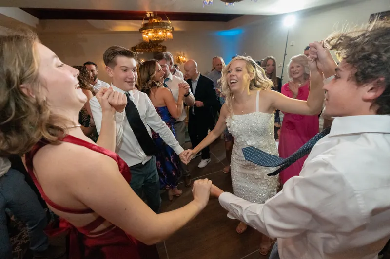 Rhett dances in the center while surrounded by guests clapping and celebrating at Casa Monica Resort & Spa.
