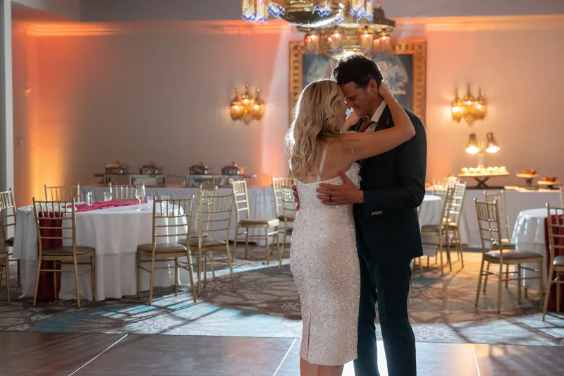 Kerry and Rhett embrace on the dance floor at Casa Monica Resort & Spa, surrounded by candlelit tables and warm orange
