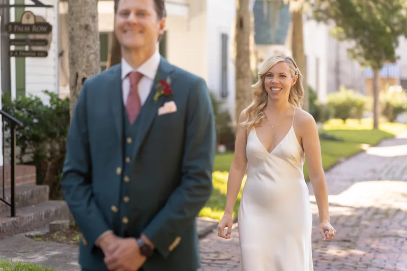 Kerry in a sleek white gown and Rhett in his teal suit walk together down the colonnade at Casa Monica Resort & Spa.