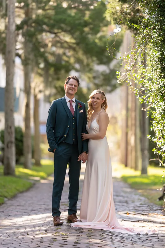 Kerry and Rhett walk arm-in-arm down a brick pathway lined with ivy-covered walls at Casa Monica Resort & Spa.