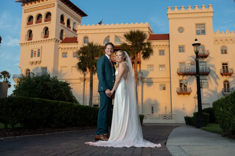 Kerry and Rhett stand beneath the ornate towers of Casa Monica Resort & Spa, exchanging a tender moment in afternoon