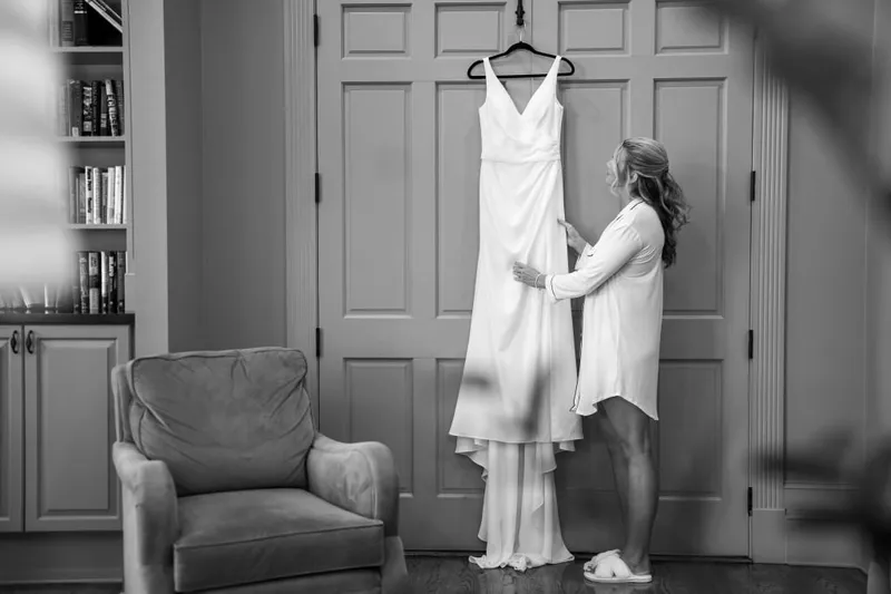 Bride admiring her elegant wedding dress