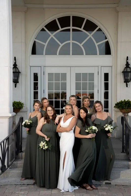 Bridesmaids in olive green dresses with white bouquets