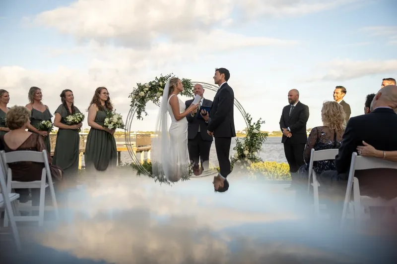Outdoor waterfront wedding ceremony at River House