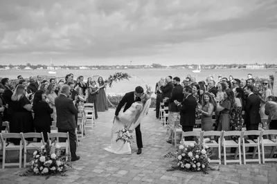 Romantic dip kiss after wedding ceremony at River House