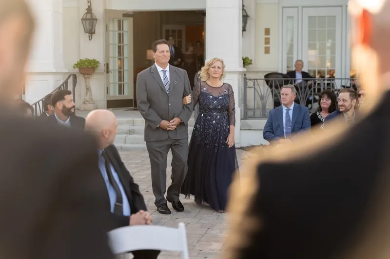 Guests gather on the portico of River House Events as the ceremony begins on the outdoor steps.