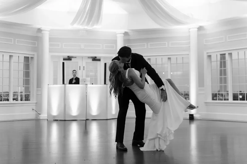 Landon dips Kimberly in a dramatic dance move across the polished ballroom floor in black and white.