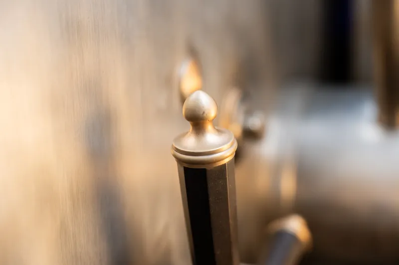 A single lit candle flame glows warmly against a blurred indoor background at The Treasury on the Plaza.