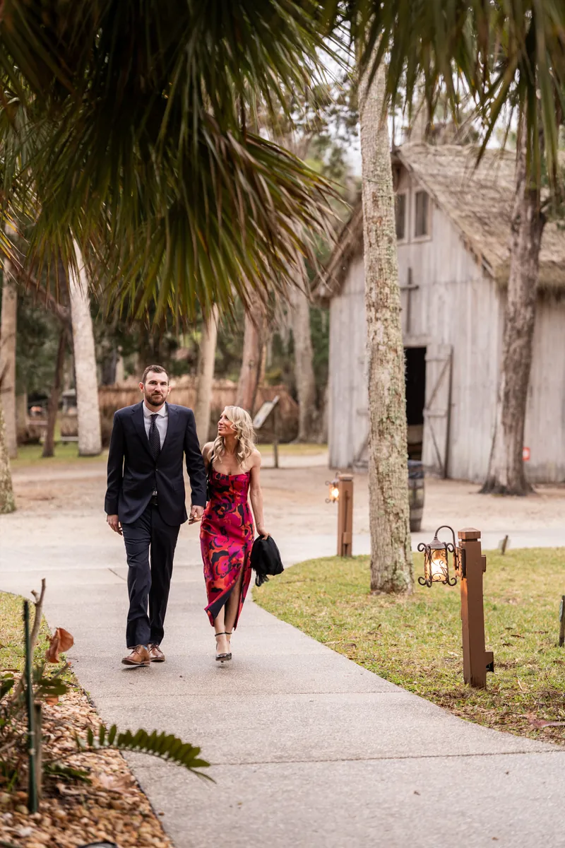 Guests arriving on the walkway through the Fountain of Youth grounds with palm trees and historic buildings