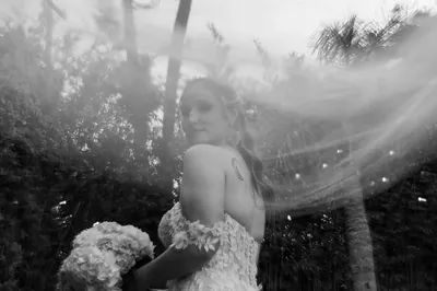 Bride Kyra black and white portrait with veil in rain at Brick and Beam