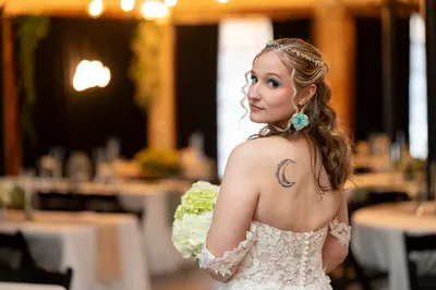 Bride Kyra portrait with hydrangea bouquet showing moon tattoo at Brick and Beam