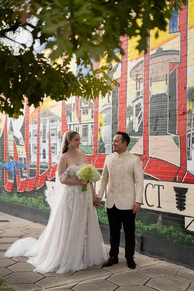 Kyra and Judd portrait on rooftop with Jacksonville skyline at Brick and Beam