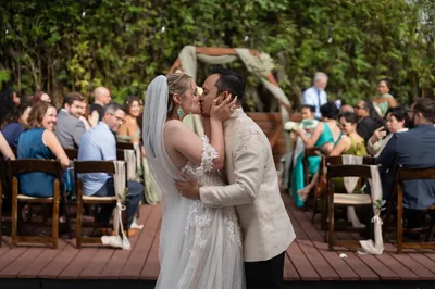 Kyra and Judd first kiss at ceremony with guests at Brick and Beam